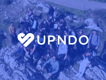 Group of people outdoors with the UPNDO logo highlighted.